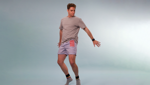 A young man with a tandem tslim insulin pump is wearing blue and white striped boxers with a red gingham pocket that holds the device. He's jumping in the air and his insulin pump is safely in the red pocket.