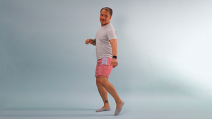 A man with a tandem tslim insulin pump is wearing red gingham boxers with a blue and white striped pocket that holds the device. He's jumping in the air and his insulin pump is safely in the blue striped pocket.